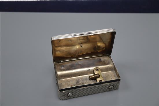 A late 18th/early 19th century French engraved and reeded white metal rectangular musical box (a.f.), 88mm.